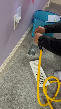 Professional HVAC technician performing air duct cleaning service